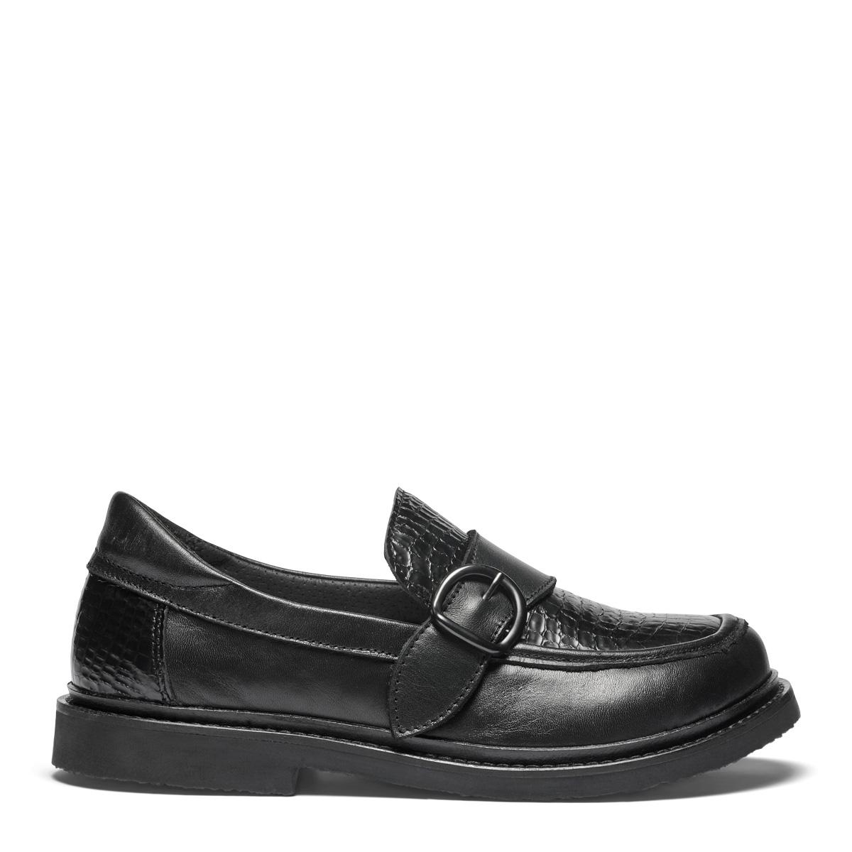 Women's loafers featuring a decorative buckle on a velcro strap