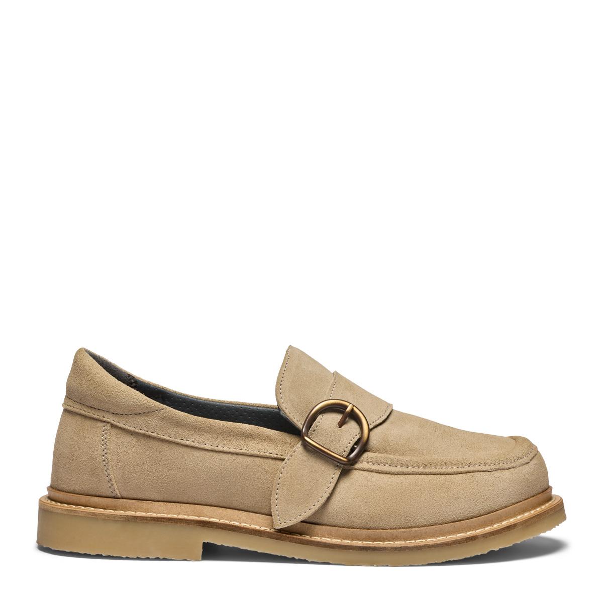 Women's loafers featuring a decorative buckle on a velcro strap