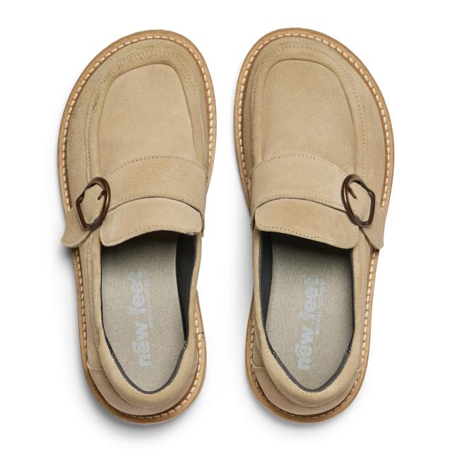 Women's loafers featuring a decorative buckle on a velcro strap
