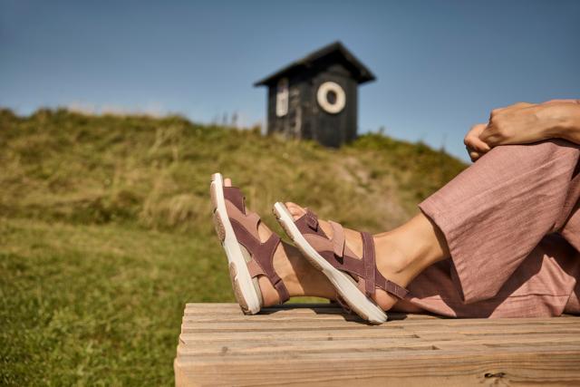 Women's sandal with an adjustable heel strap and three Velcro straps across the foot